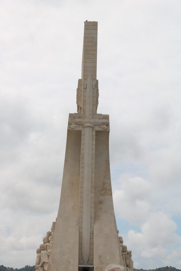 back view of the white stone monument with a large sword on the back edge
