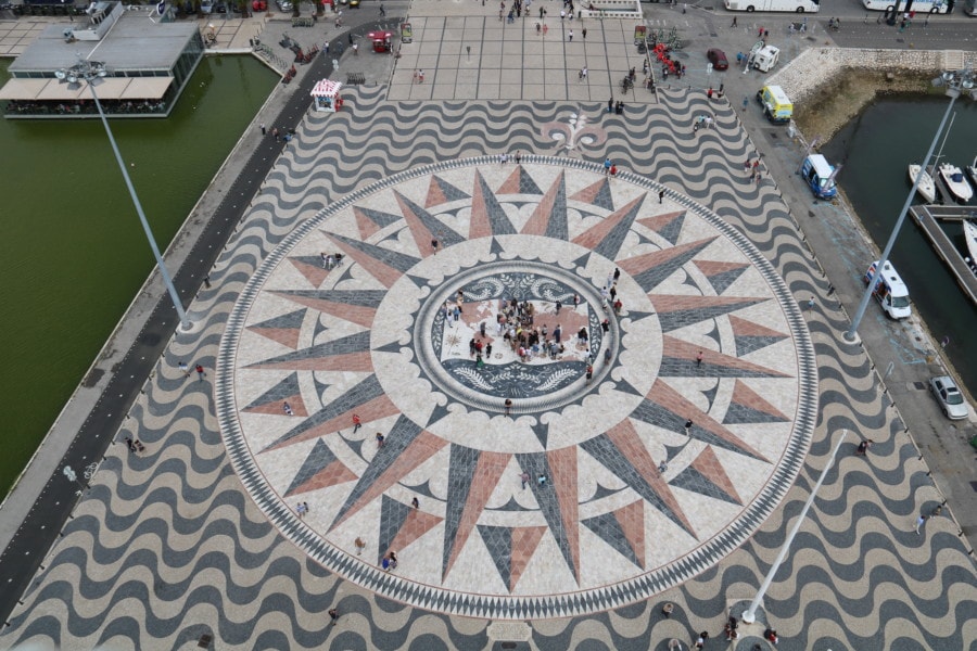 view of ??? from top of monument showing pink and black triangles surrounding circle with map of the world