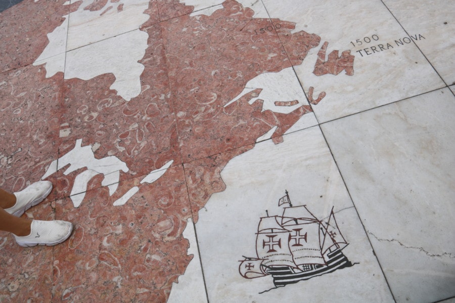 close up of stone map on ground showing pink world map of Canada