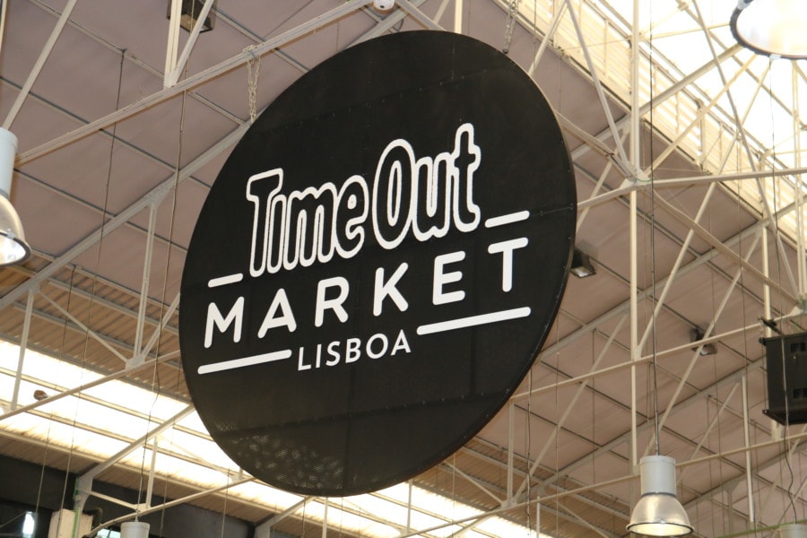 large circle black sign that says TimeOut Market Lisboa