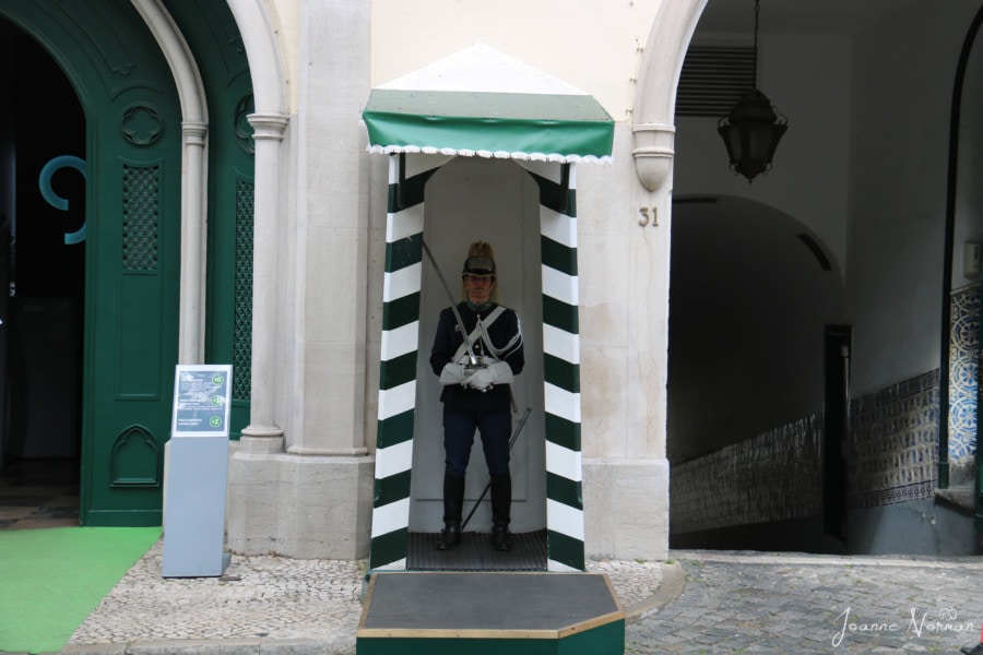 national guard in small hut with stripes on sides and green canopy cool thing in Lisbon with kids