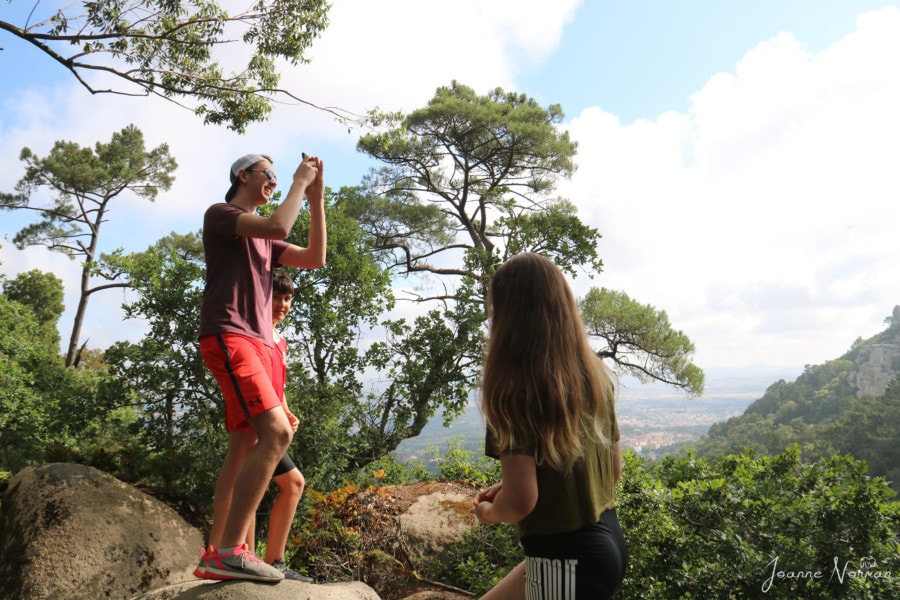 Lucas and Sydney on rock taking photos