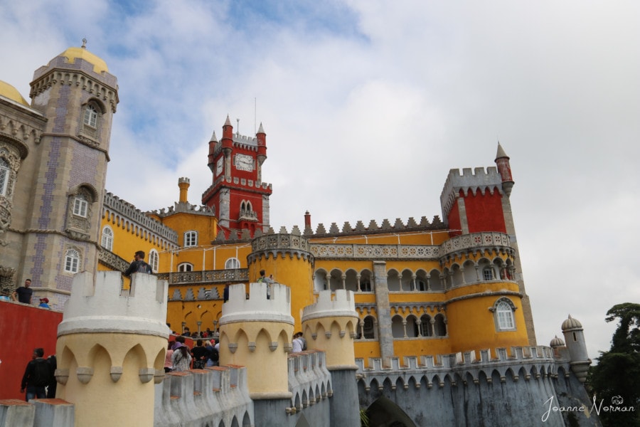 orange and yellow buildings with decorative white trim