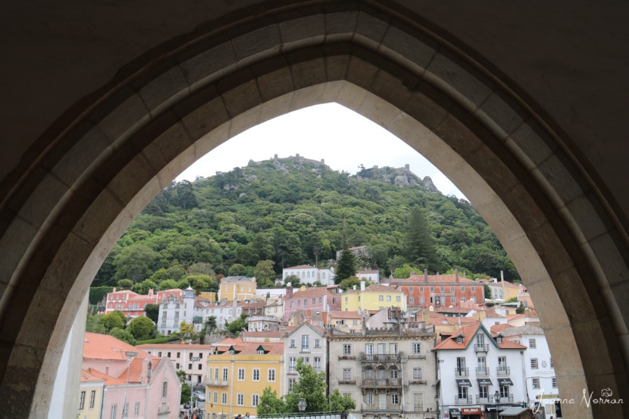 view of Sintra village and moorish castle through archway