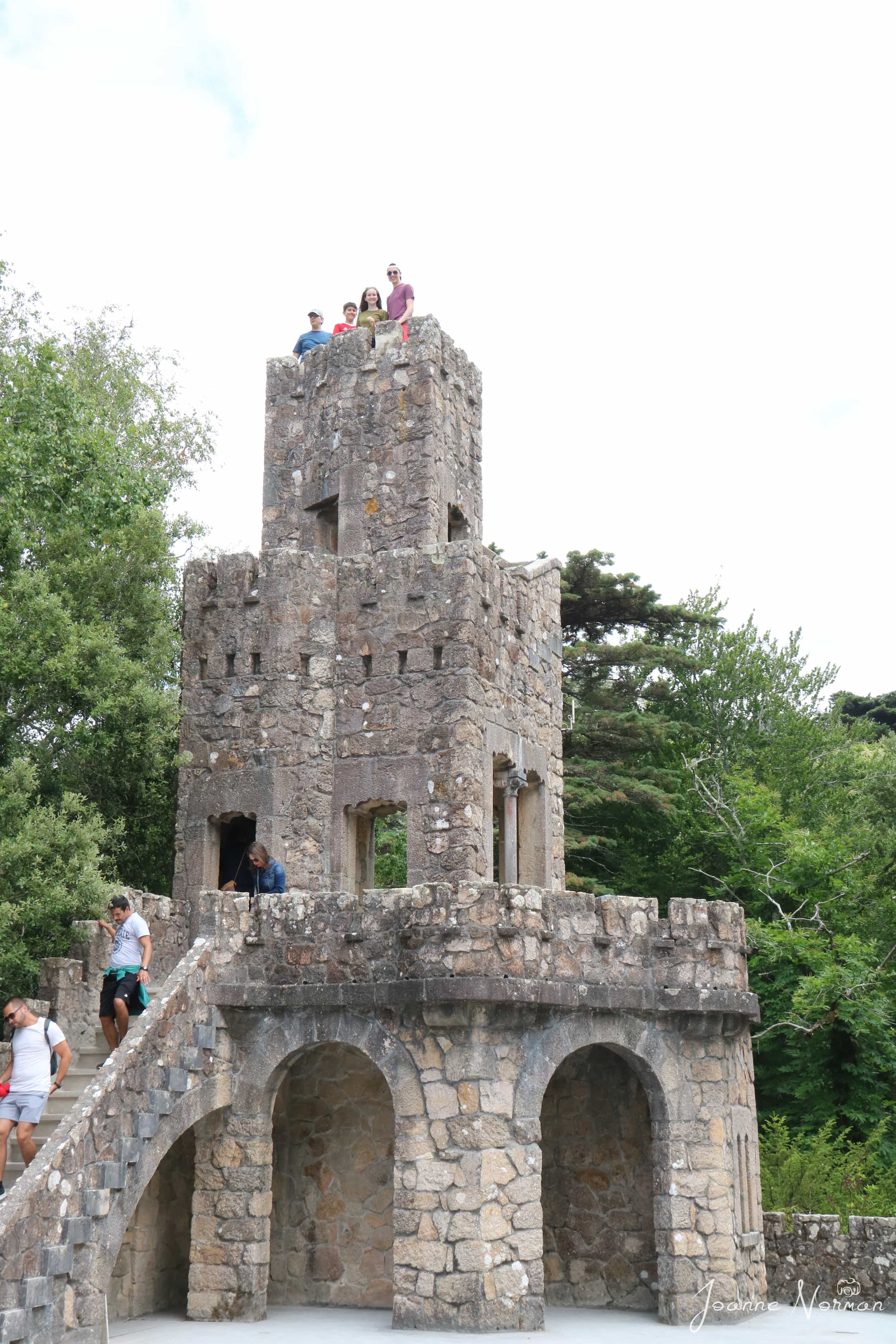 tall minicastle of stone with my three kids and John at top