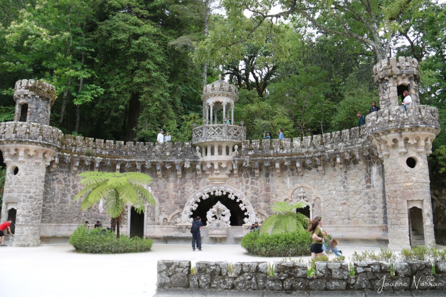 large stone semi circle with decorative edges and Syd running in front