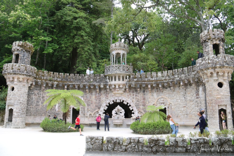 large stone semi circle with decorative edges and Lucas running after Syd