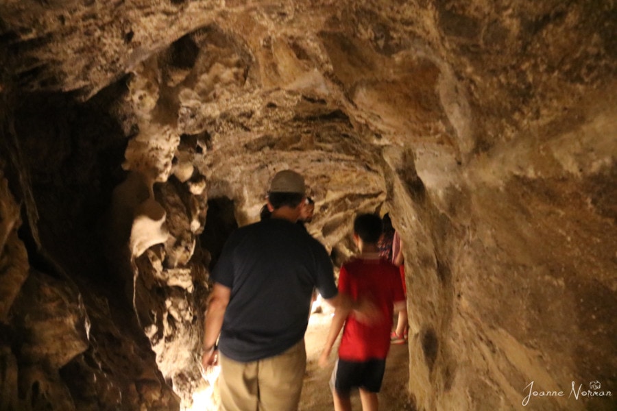 blurry of John and Caiden walking through cave