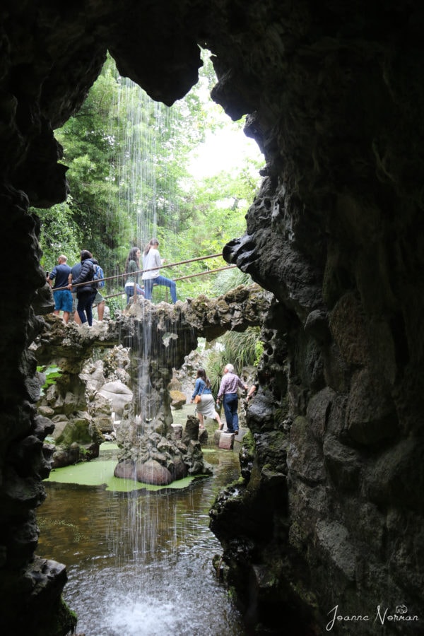 view from behind slight waterfall looking across to bridge