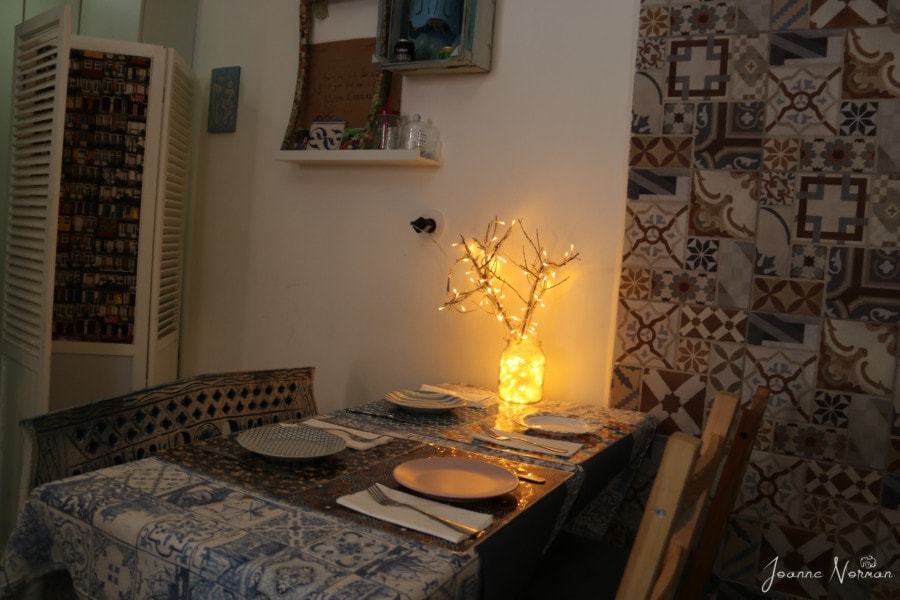 interior of Beco a Serio with table set for four and light up branches on table
