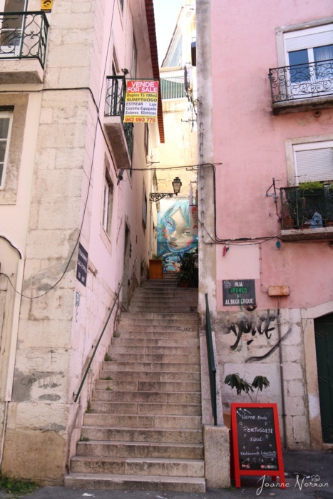 Steep stairs between pink buildings is Lisbon Tue e eu 2 portuguese restaurant in lisbon alfama restaurant