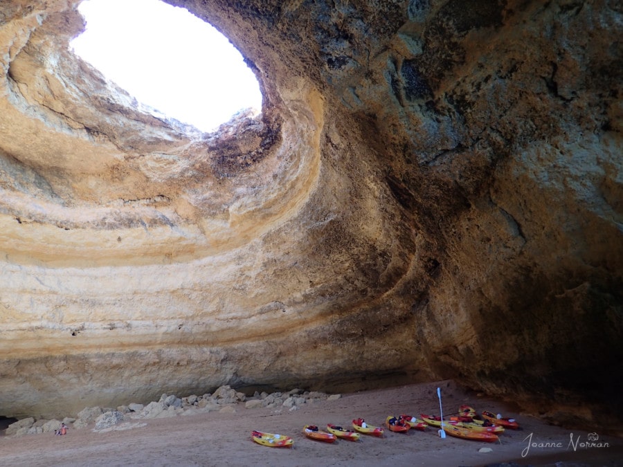hole in top of Benagil Cave Carvoeiro Algave with paddle boards and canoes on beach below
