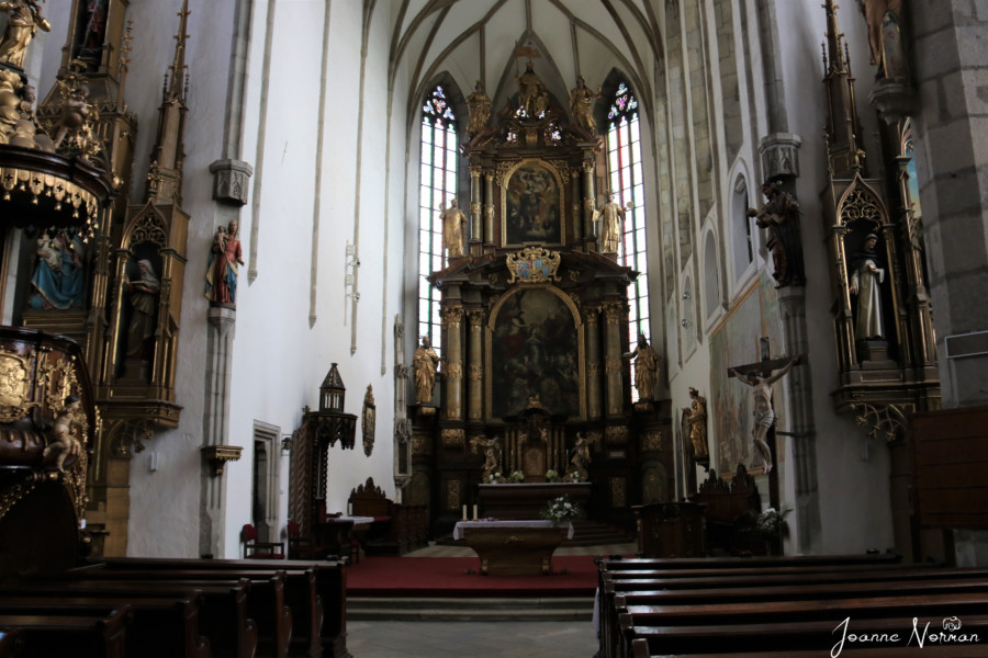 interior of church showing pews and altar things to do in Cesky krumlov