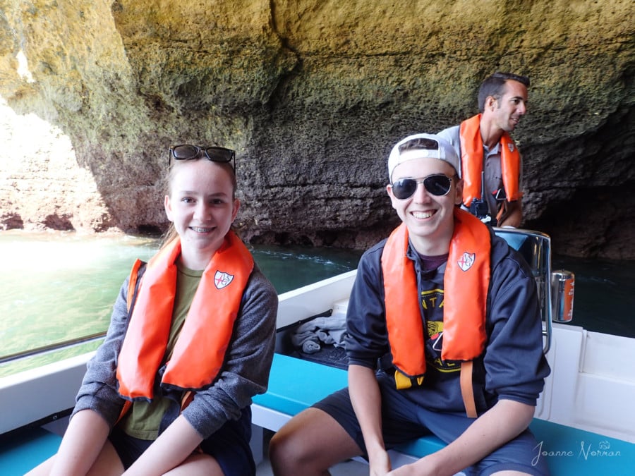 Sydney and Lucas smiling in boat inside Benagil Cave with our tour guide