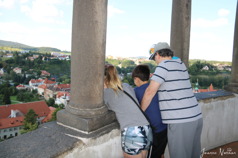 kids and John looking over the railing at top of Cesky Krumlov tower