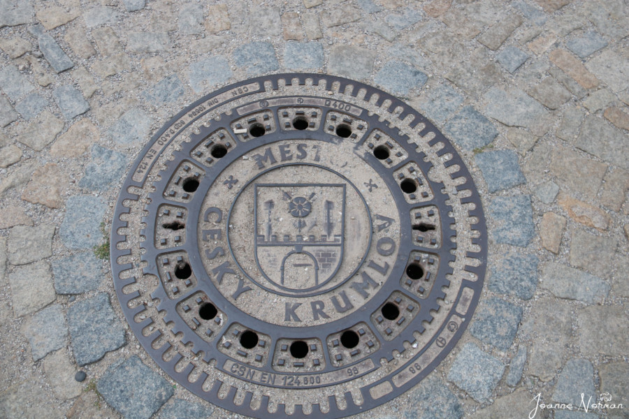 manhole cover with crest and roses