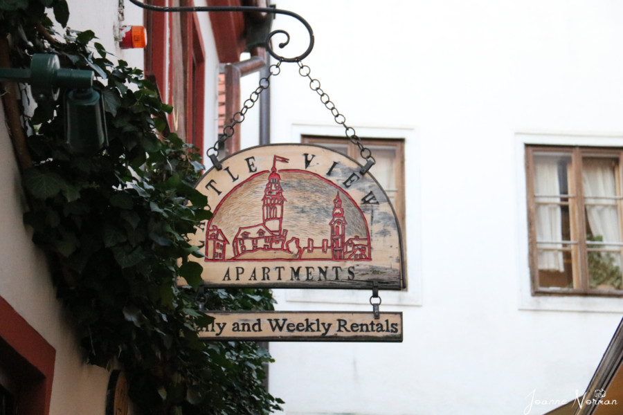 wooden sign stating castleview apartments cesky krumlov