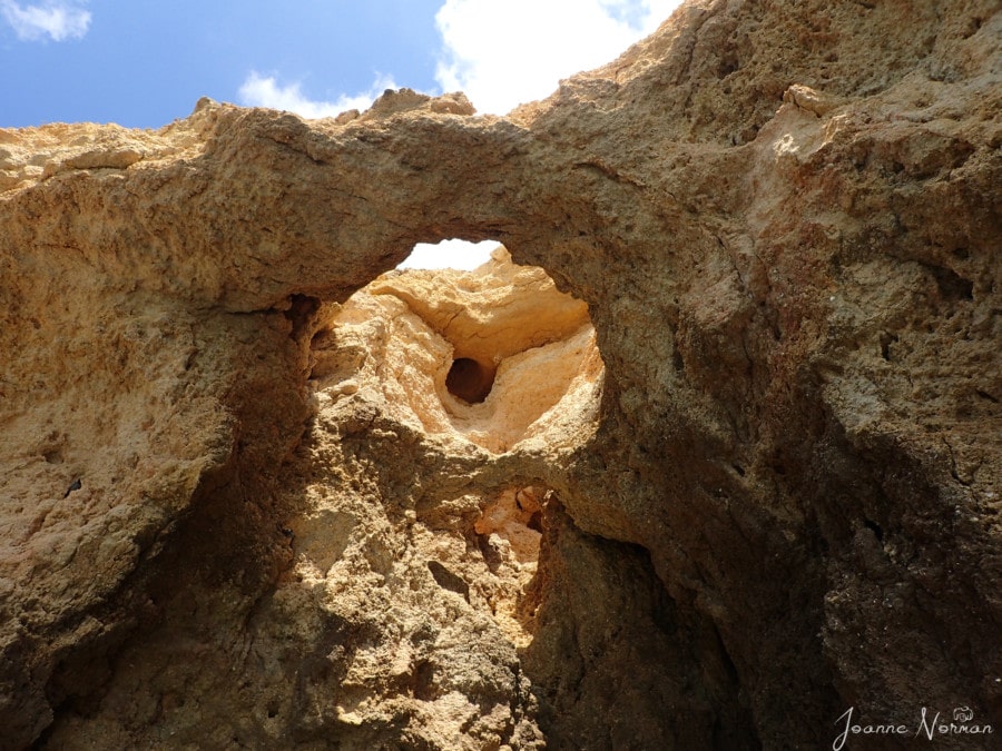 cave with hole in sandstone roof sandstone rock in water Ponta da Piedade Lagos