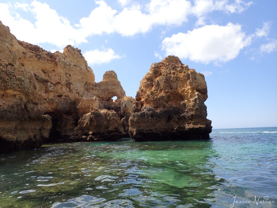 large rock formations jutting from ocean in Lagos Ponta da Piedade