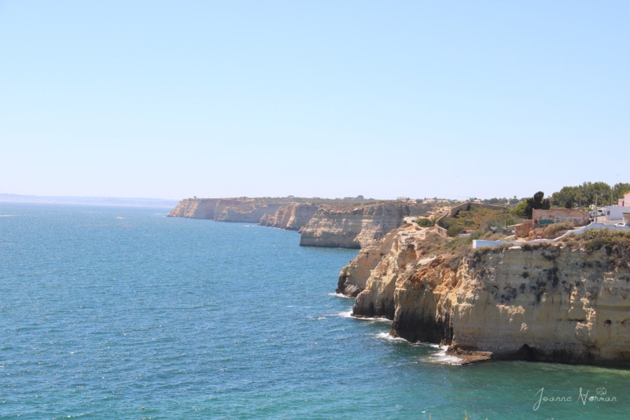 sandstone cliffs with blue ocean beating below things to see in Carvoeiro boardwalk