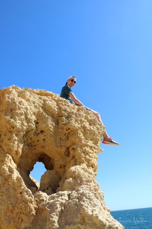 Lucas sitting on orange cliff