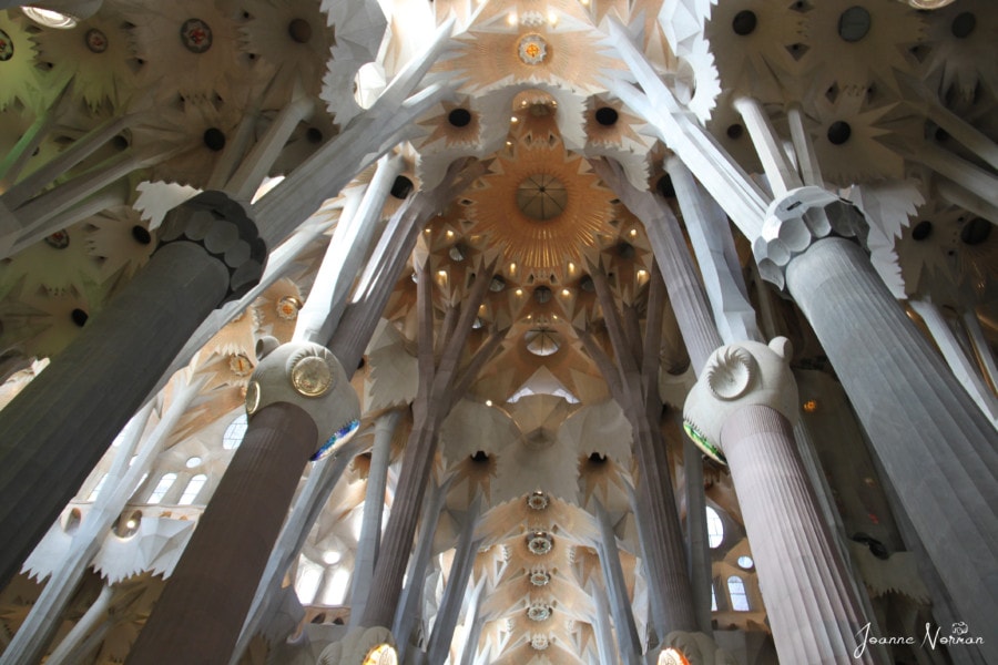 white interior of large church with pillars like trees is sagrada family perfect Spain itinerary