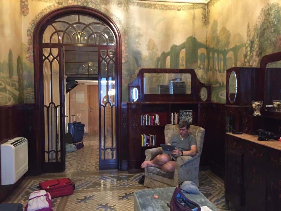 man in chair in apartment with fresco walls Barcelona itinerary