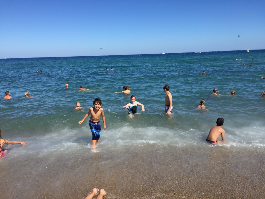 three kids playing in water Barcelona itinerary