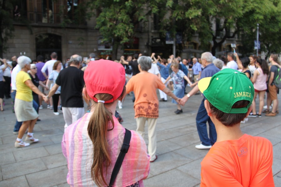 3 days in Barcelona includes kids watching group in circle holding hands while dancing
