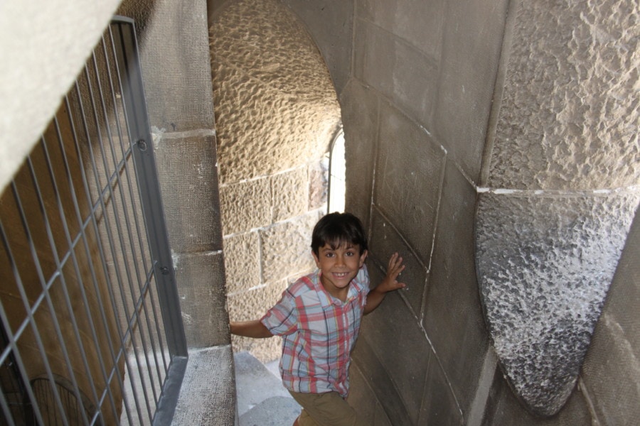 caiden in stone stairwell smiling 