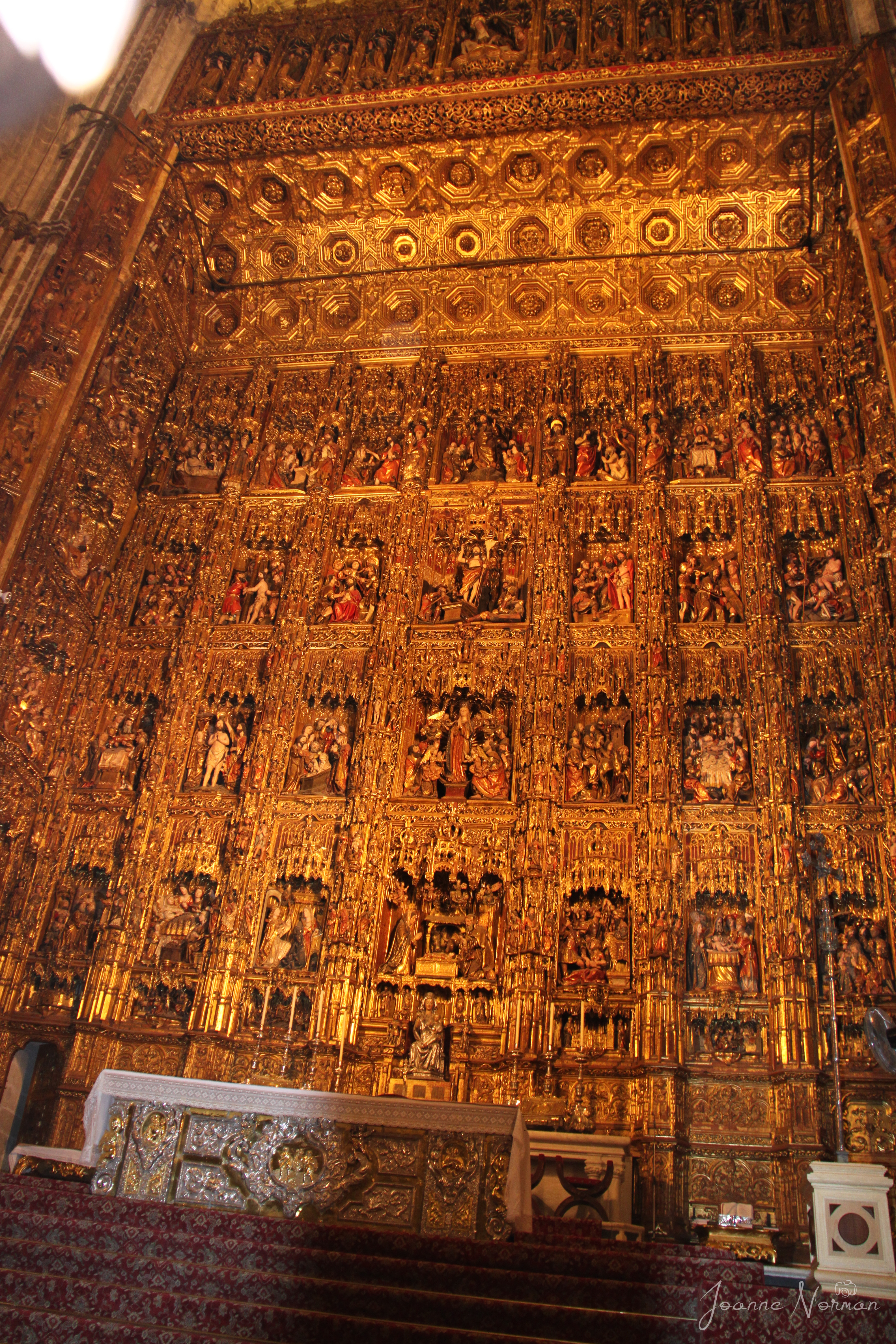 golden wall with carved scenes things to do in Seville