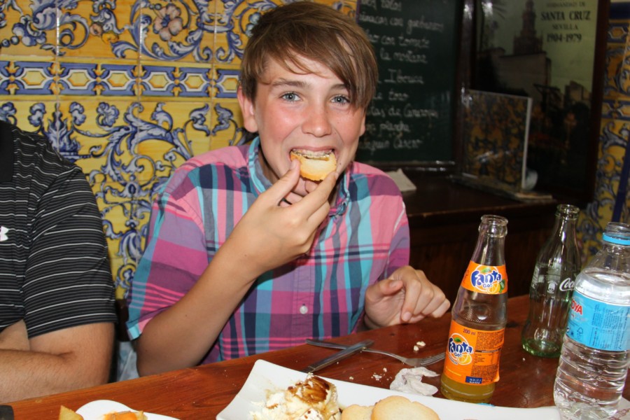 Lucas enjoying crackers with cheese tapas in seville