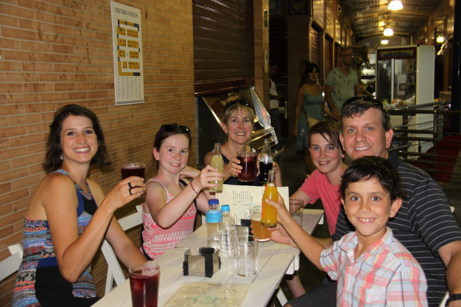 us and our guide giving toast to wonderful food on tapas tour