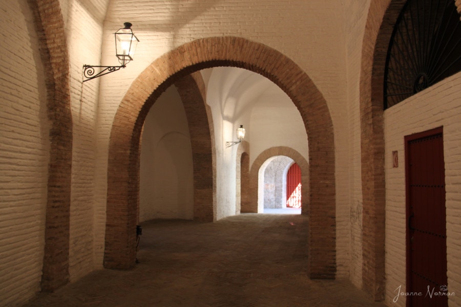 hallway with arches leading to museum