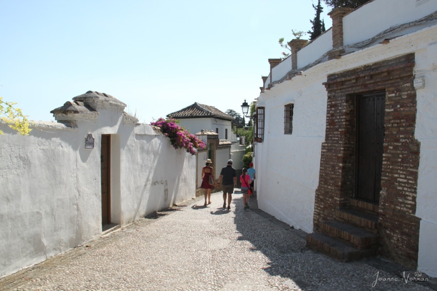 Granada guide walking family of five through white houses narrow streets of albaicin granada