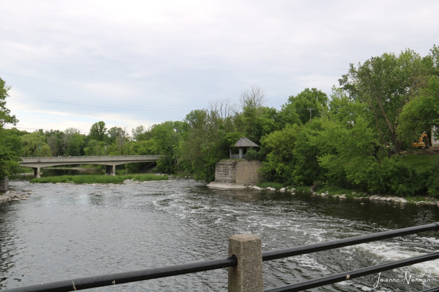 river with small brick pergola on the right