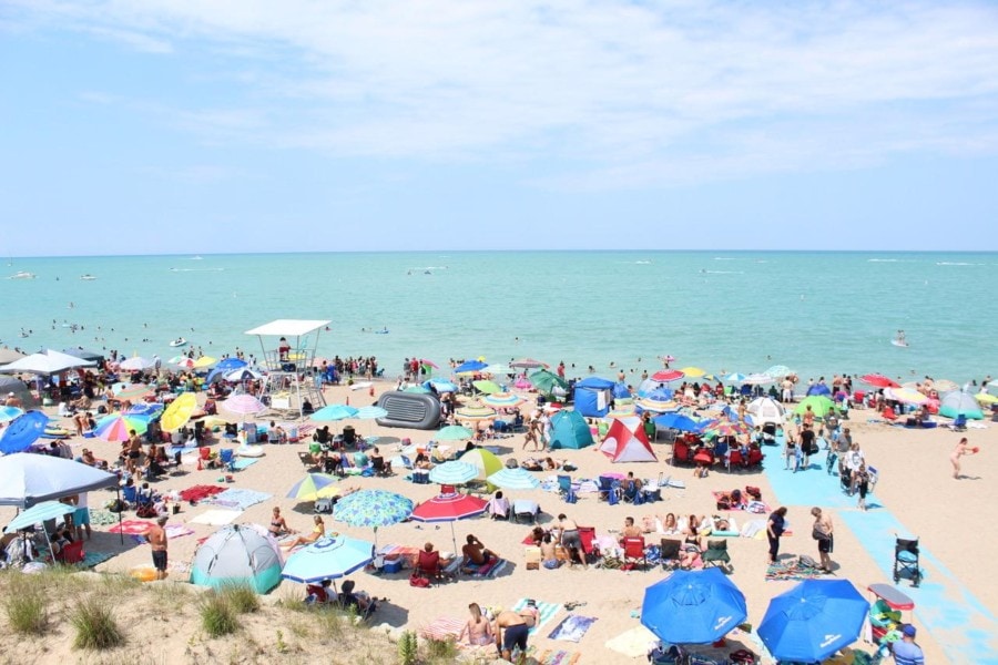 beach with many beach umbrellas and people