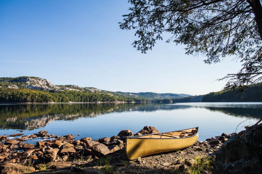 canoe on edge of calm lake