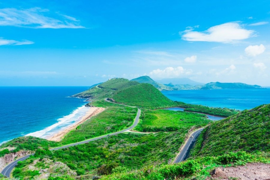 green lush mountain set against bright blue sea instagrammable caribbean st kitts nevis