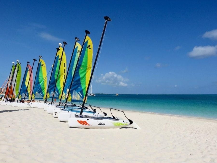 colourful kite surfers sitting on a beach instagrammable caribbean turks caicos