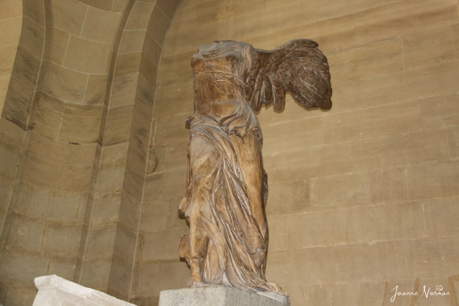 headless statue of lady with wings