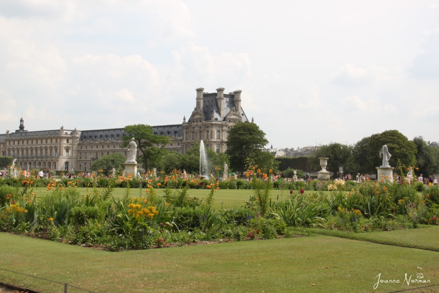 beautiful gardens with large palace like building behind
