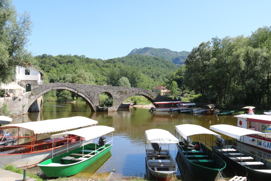 Rijeka Crnojevića Bridge and colourful boats Montenegro