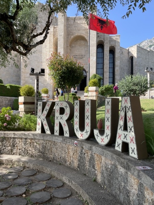 Kruja town sign with castle in background