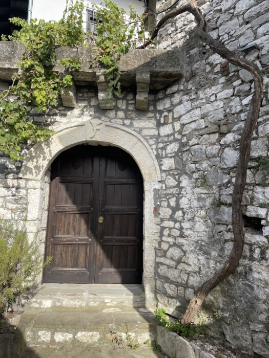 brown oval door with stone around