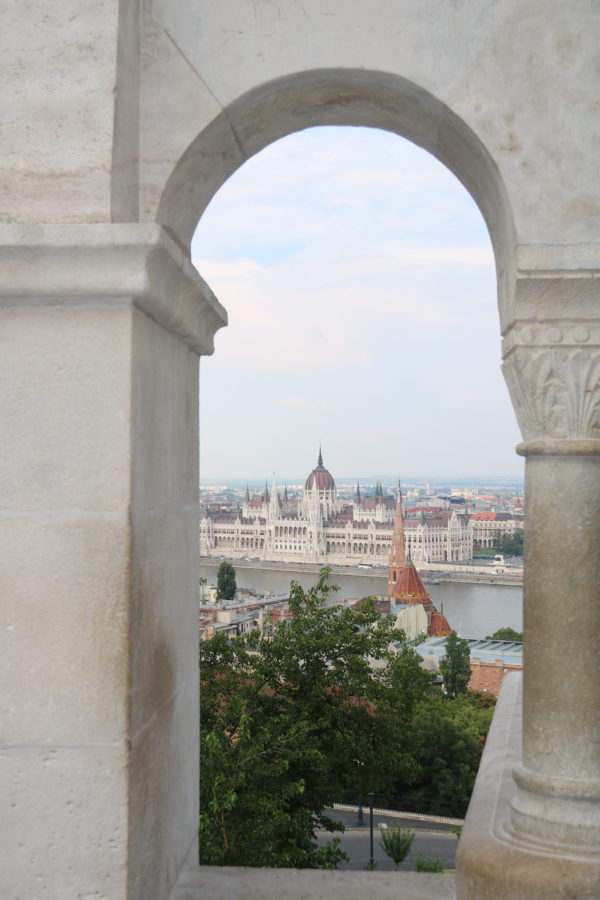 View of Budapest Parliament through single arch of Fisherman's Bastion on Castle Hill is one of best views in Budapest